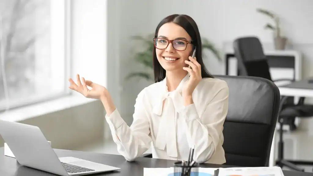 Professional staff member smiling during a phone call in the All County Tax Resolution office, Wayne County, Pennsylvania, offering expert tax solutions to clients with a positive attitude