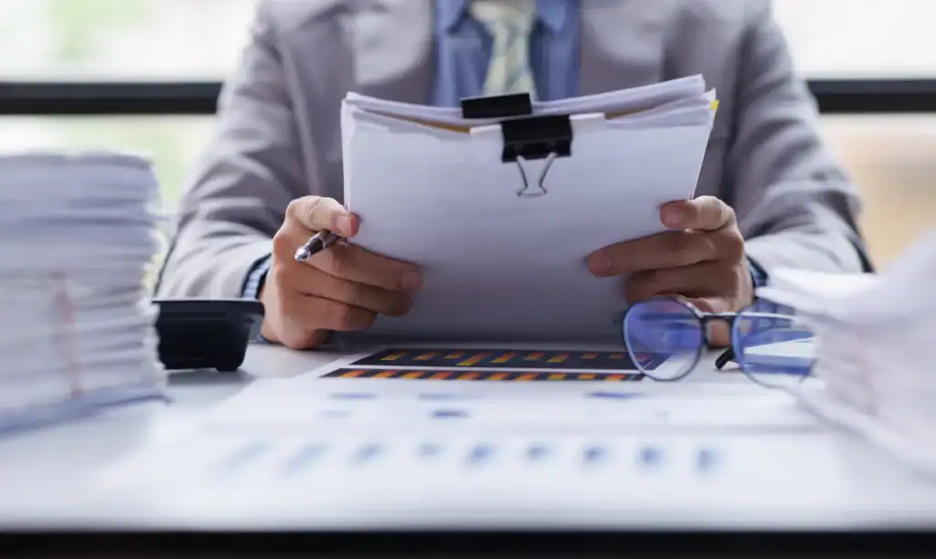 Unpaid tax resolution documents and paperwork on a desk for tax relief services.